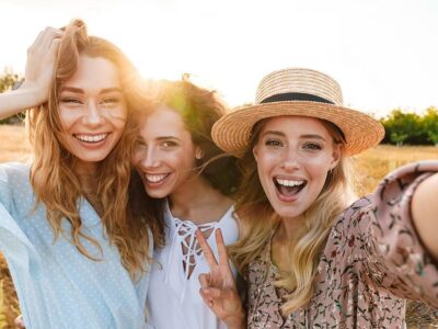 Photo of joyful caucasian women taking selfie photo